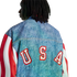 Back view of a person with dreadlocks wearing a denim jacket with red and white striped sleeves and large red "USA" lettering across the back.