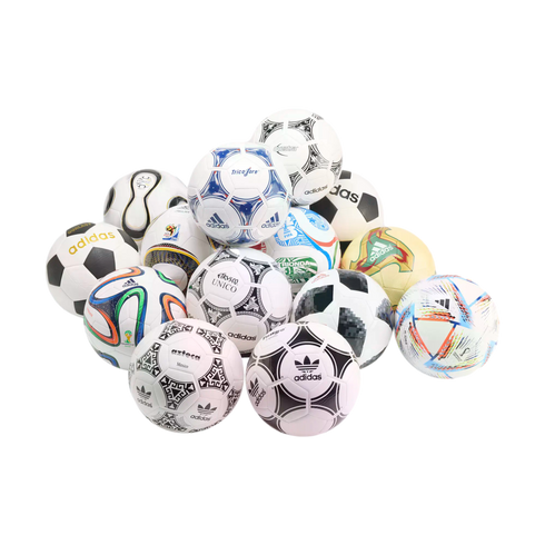 A pile of various Adidas FIFA World Cup official match balls from different years, arranged against a solid black background.
