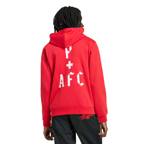 Back view of a person wearing a red hoodie with white Gothic text reading 'P + AFC' and black pants featuring a red Arsenal cannon logo, set against a black background.