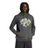 A Black man with dreadlocks wears a grey Adidas FIFA World Cup hoodie with colorful cartoon mascots on the chest, standing against a black background.