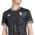A man wearing a black Adidas jersey with a subtle floral tonal pattern, striped collar, Adidas Trefoil logo, and a lion crest on the chest.