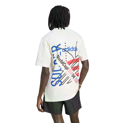 Rear view of a person with dreadlocks wearing a white t-shirt with a large World Cup USA 94 graphic and black shorts.