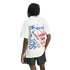 Rear view of a person with dreadlocks wearing a white t-shirt with a large World Cup USA 94 graphic and black shorts.