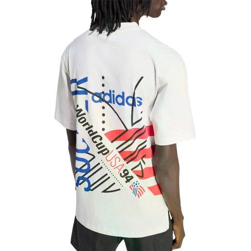 Rear view of a person with dreadlocks wearing a white Adidas t-shirt featuring a colorful "World Cup USA 94" graphic design on the back.