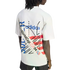 Rear view of a person with dreadlocks wearing a white Adidas t-shirt featuring a colorful "World Cup USA 94" graphic design on the back.