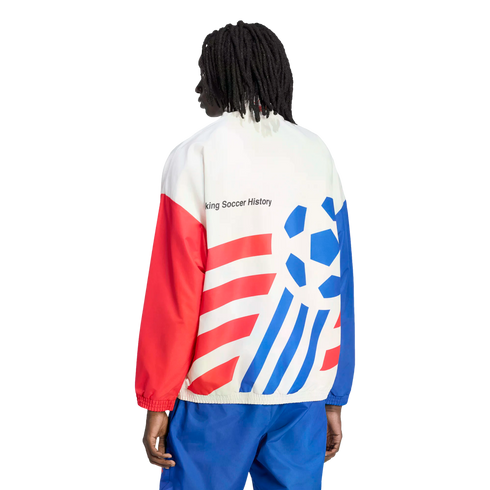 Back view of a person with dreadlocks wearing a white, red, and blue track jacket and blue pants against a black background. The jacket features bold red diagonal stripes on one side, a blue stylized soccer ball graphic on the other, and the text "king So