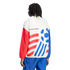 Back view of a person with dreadlocks wearing a white, red, and blue track jacket and blue pants against a black background. The jacket features bold red diagonal stripes on one side, a blue stylized soccer ball graphic on the other, and the text "king So