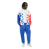 A person models a vintage-style Adidas World Cup USA '94 tracksuit against a black background. The white jacket features bold blue and red graphics, including a soccer ball and stripes, paired with matching blue track pants and white sneakers.