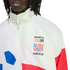 A close-up of a person wearing a white Adidas track jacket featuring the World Cup USA 94 logo on the left chest. The jacket has a high-neck zipper and red and blue color-blocked accents on the sleeves and body.