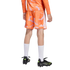 Rear view of a person wearing orange patterned soccer shorts and jersey, high white socks, and black soccer cleats against a plain white background.