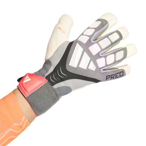 A person's hand wearing a grey and white Adidas Predator goalkeeper glove with a red wrist strap, set against a solid black background.