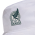 A close-up of a white bucket hat featuring a dark green and white patch. The patch depicts a stylized Aztec eagle, a soccer ball, and the word "MÉXICO" at the bottom.