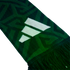 Close-up of a green knitted scarf with a white three-stripe logo, dark geometric patterns, and a fringed edge against a black background.