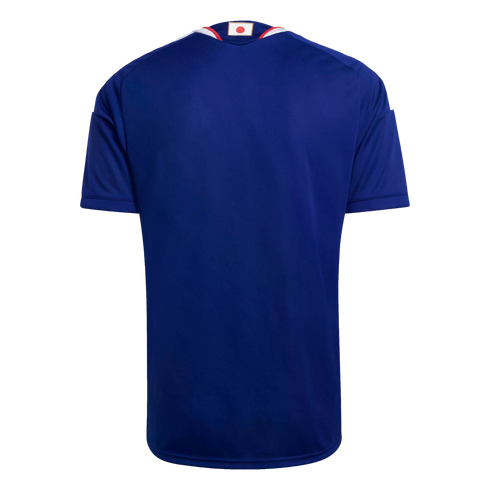 Rear view of a dark blue soccer jersey with white shoulder stripes and a small Japanese flag on the back collar.