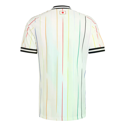 Back view of a white soccer jersey with multi-colored pinstripes, black and white striped collar and cuffs, and a small Japanese flag emblem on the upper back.