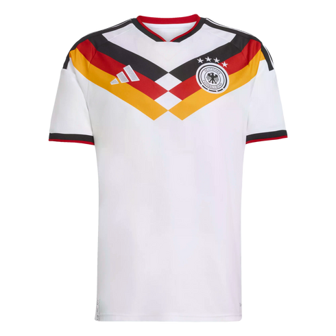 White Germany home football jersey featuring a bold black, red, and gold V-shaped pattern on the chest, team crest, and silver Adidas logo.