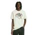 A person with dreadlocks wears a white Adidas FIFA World Cup t-shirt featuring mascot graphics and dark jeans, shown against a solid black background.