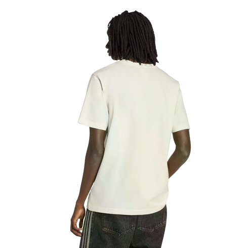 Rear view of a person with long dreadlocks wearing a plain white t-shirt and dark jeans against a black background.