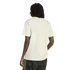 Rear view of a person with long dreadlocks wearing a plain white t-shirt and dark jeans against a black background.
