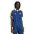 A person with dreadlocks wearing a navy blue Real Madrid soccer jersey and matching track pants against a black background.