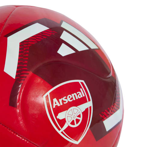 Close-up of a red Adidas soccer ball featuring the Arsenal Football Club crest.