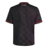 Back of a black short-sleeved jersey with a tonal checkerboard pattern, "FCBM" on the upper back, and red-and-black checkered trim on the olive green collar and sleeve cuffs.