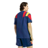 Back view of a person wearing a blue soccer kit with red and yellow shoulder details against a white background.