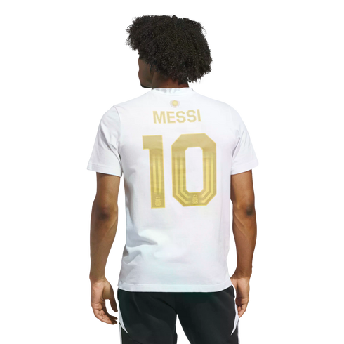 Rear view of a man in a white T-shirt featuring gold "MESSI 10" lettering on the back. He has dark curly hair and wears black athletic shorts against a black background.