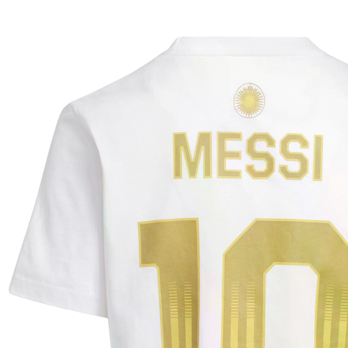 Back of a white jersey showing "MESSI" and the number "10" in gold lettering, with a gold sun emblem above the name.