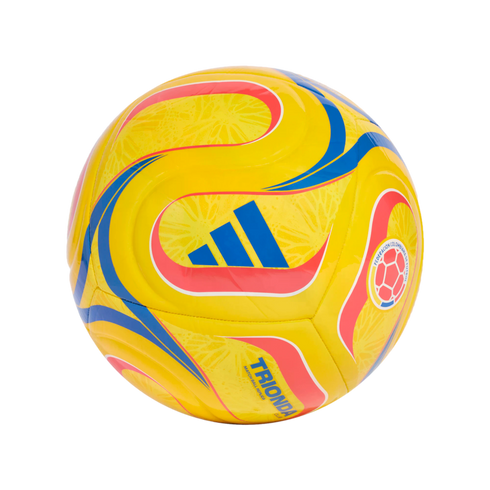 A bright yellow soccer ball with blue and red swirl patterns, featuring the blue Adidas logo and the Colombian Football Federation crest. "TRIONDA CLUB" is printed in blue on the lower section.