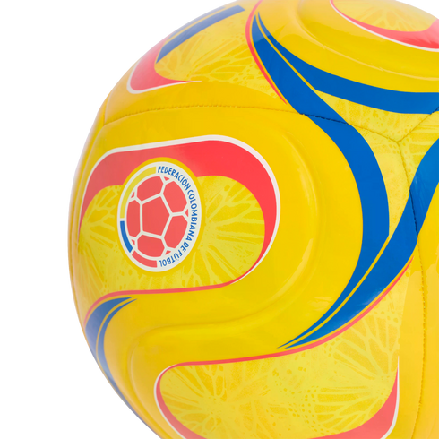 A yellow soccer ball with blue and red wavy designs, featuring the logo of the Federación Colombiana de Fútbol.