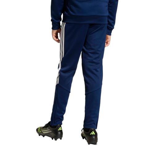 Rear view of navy blue Adidas track pants with white side stripes, paired with black soccer cleats.