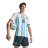 Man in a blue and white striped Argentina soccer jersey with number 10, holding a football under his arm against a black background.