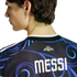 Back view of a person wearing a black Argentina soccer jersey with blue swirl patterns and "MESSI" printed in bold white letters.