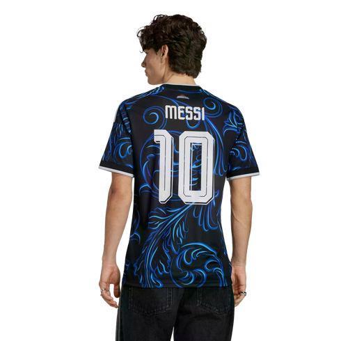 Rear view of a man wearing a black and blue patterned soccer jersey with "MESSI 10" on the back, against a solid black background.
