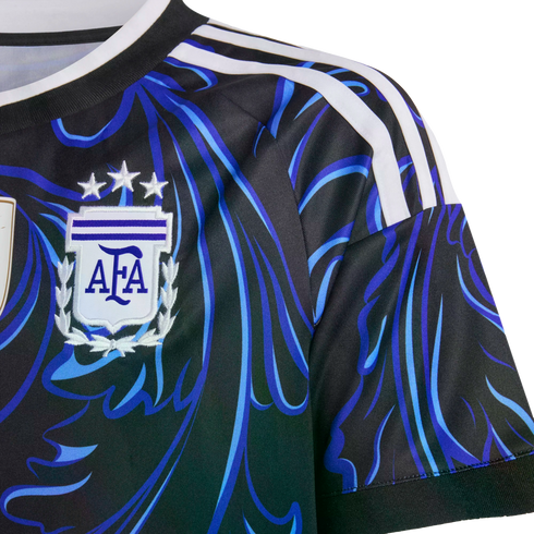 Close-up of an Argentina soccer jersey featuring a black and blue swirling pattern, white shoulder stripes, and the AFA crest with three stars.