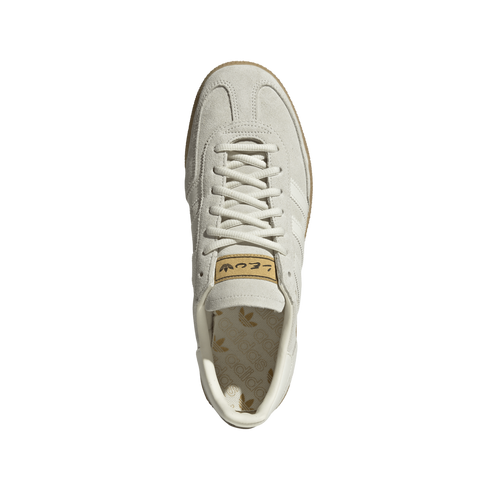 A top-down view of a light gray suede Adidas sneaker with matching laces and a gum rubber outsole, centered on a white background.
