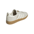 Rear-quarter view of an off-white Adidas Samba shoe with gold Messi branding and a gum rubber sole.