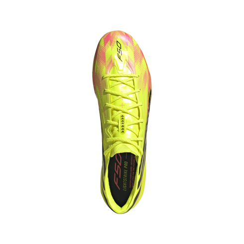 Top-down view of a neon yellow and pink Adidas F50 soccer cleat with matching laces against a black background.
