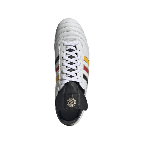 Top-down view of a white leather soccer cleat with black, red, and yellow stripes and a black tongue featuring a gold DFB logo, set against a black background.