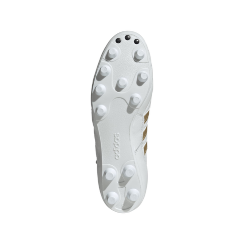 The white sole of an Adidas soccer cleat with molded studs and three small black toe studs, centered against a solid black background.