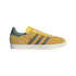Side view of a yellow suede sneaker with grey stripes, red zig-zag stitching, white soles, and "Bob" written in script on the side.