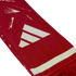 A red knitted scarf featuring a white Adidas logo, a white horizontal stripe, and red fringe at the end.