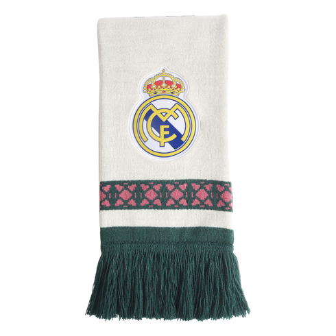 White knit scarf featuring a centered Real Madrid crest, a green horizontal band with pink geometric patterns, and long dark green fringe.