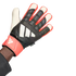 An Adidas Predator goalkeeper glove in black, coral, and white, featuring the brand's logo and "PRED" text. The glove is worn on a hand against a plain white background.