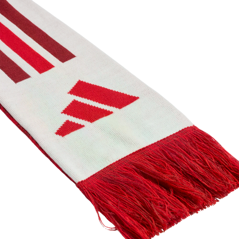 Close-up of a white knitted scarf with red fringe, featuring the red Adidas three-bar logo and diagonal red and maroon stripes.