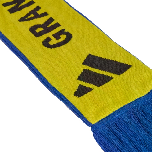 A yellow and blue knitted scarf with a black Adidas logo and partial black text reading "GRAN".