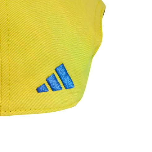 Close-up of a blue Adidas logo embroidered on yellow twill fabric.