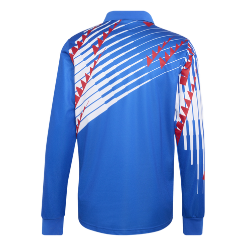 Back view of a blue long-sleeve polo shirt featuring a white diagonal stripe graphic with red geometric accents across the upper back and right sleeve.