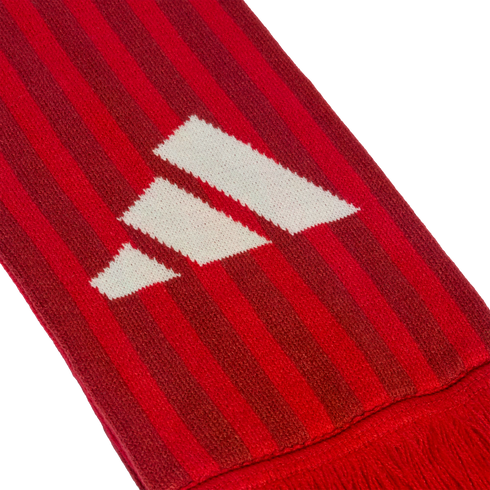 Close-up of a red and dark red striped knitted scarf featuring a white Adidas logo.